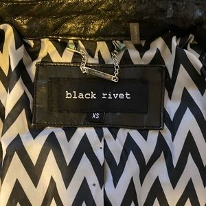 Black Rivet Leather Jacket with zebra print lining.